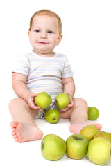 baby with green apples over white