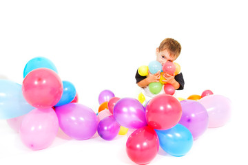 Fototapeta na wymiar cute boy playing with colorful balloons over white