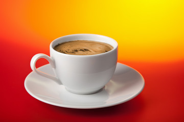 cup of coffee over red and yellow background