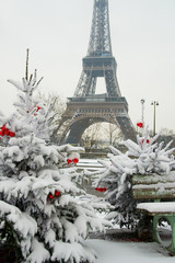 Rare snowy day in Paris. The Eiffel Tower and decorated Christma