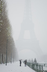 Rare snowy day in Paris. Misty Eiffel Tower, Champ de Mars and l