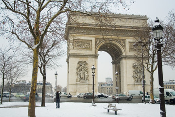Rare snowy day in Paris. Arc de Triomphe and lots of snow