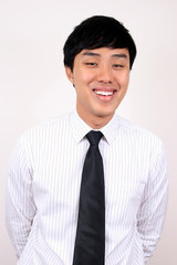 Young asian businessman smiling.
