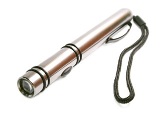 Metallic flashlight is isolated on the white isolated.
