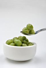 some organic and fresh pea in a white bowl