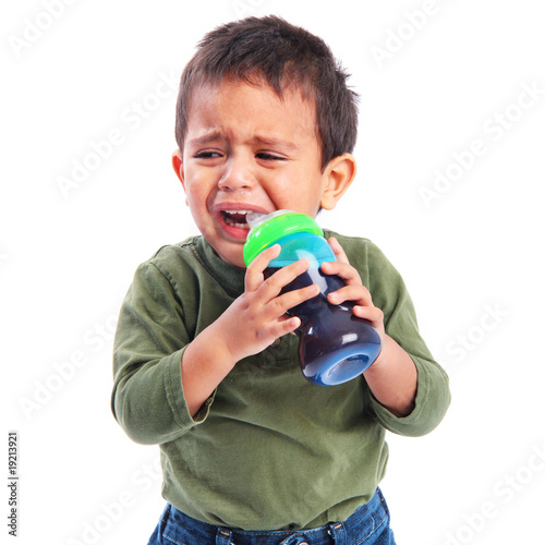 "Upset Sad Toddler Crying while Drinking from a Sippy Cup" Stock photo