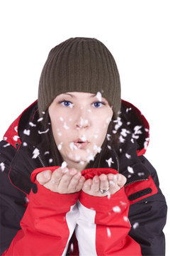 Woman blowing soft white flakes