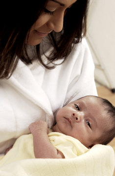 Hispanic mother holding infant