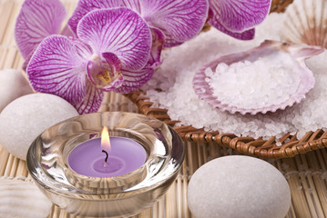 Candle, salt, stones and orchid