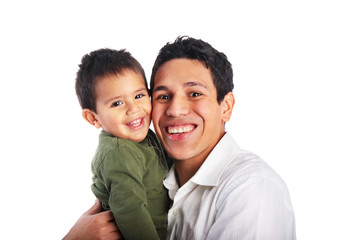 Dad hugging toddler son smiling