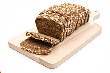 sliced wholemeal bread on kitchen board isolated