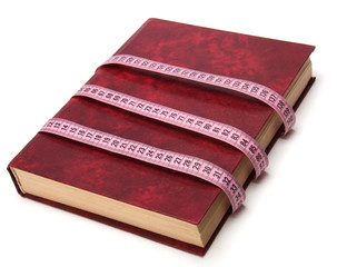 tape measure wrapped around book isolated on white background