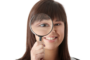 business woman looking into a magniying glass