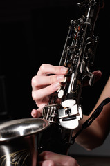 Fototapeta premium hand on buttons of saxophone