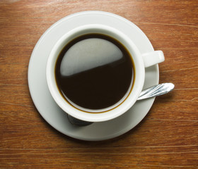 Coffeecup with Coffee in it on a wooden table