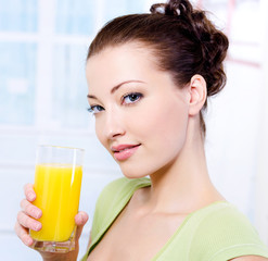 girl with a glass of fresh orange juice