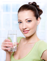 beautiful young woman with glass of pure  water