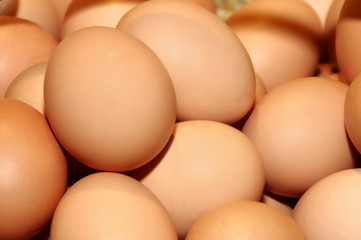 a closeup of a pile of brown eggs