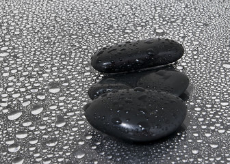 Black stones with water drops