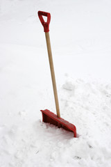 red snow showel burried in heavy snow