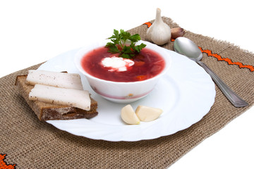 Ukrainian borsch soup bacon, bread and garlic, isolated on white