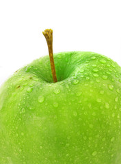 wet green apple covered with  water drops on white background.