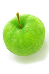 wet green apple covered with  water drops on white background.