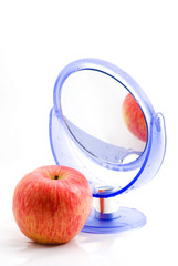 red apple and a mirror with a reflection