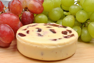 home made cheese with grapes in the background