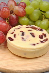 home made cheese with grapes in the background