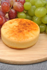 home made cheese with grapes in the background