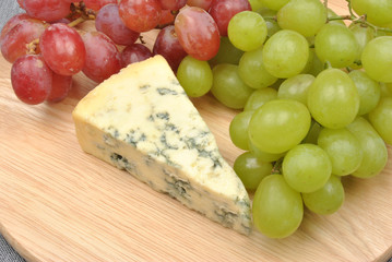 home made cheese with grapes in the background