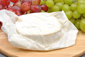 home made cheese with grapes in the background