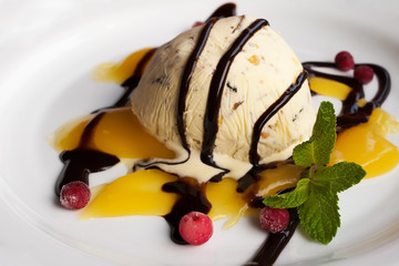 ice cream with frozen berries and sauce