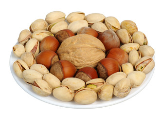 Set of nuts on a white plate, isolation
