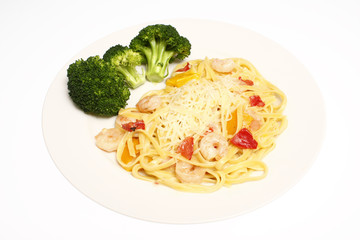 Shrimp scampi with linguine and a side of broccoli.