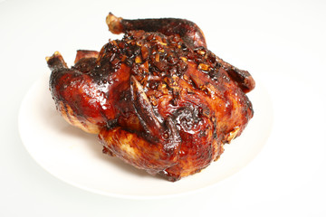 Oven baked teriyaki apple chicken isolated on white.