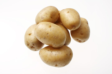 Yellow potatoes isolated on white.