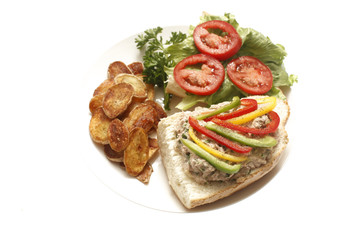 A tuna salad sandwich with potato chips.
