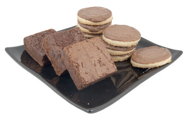 biscuits and brownies on plate isolated on white