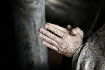 Fototapeta premium Fine art photo of hands of aged person in prayer