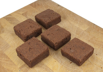Fototapeta na wymiar chocolate brownies on chopping board isolated on white