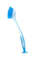 blue dishwashing brush over white background