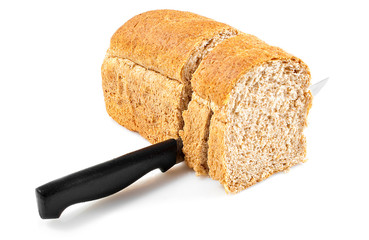 Knife cutting whole grain bread