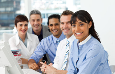 A business group showing diversity looking at the camera