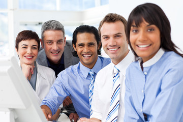 Multi-ethnic smiling business team sitting in a row