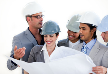 International engineers studying a construction plan