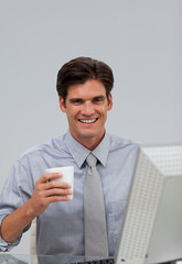 Happy caucasian businessman holding a drinking cup