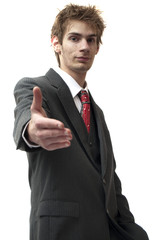 Attractive Young Businessman Greets With A Smile And A Handshake