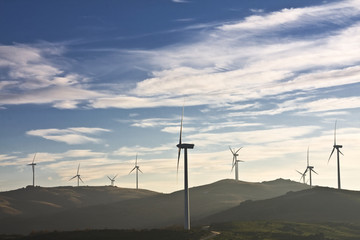 windmills in the top of a montain with blue sky and clouds, alte